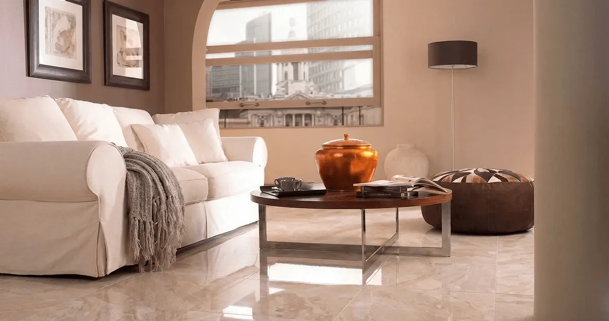 Modern living room with professionally installed marble flooring, a beige sofa, coffee table in Columbus, GA